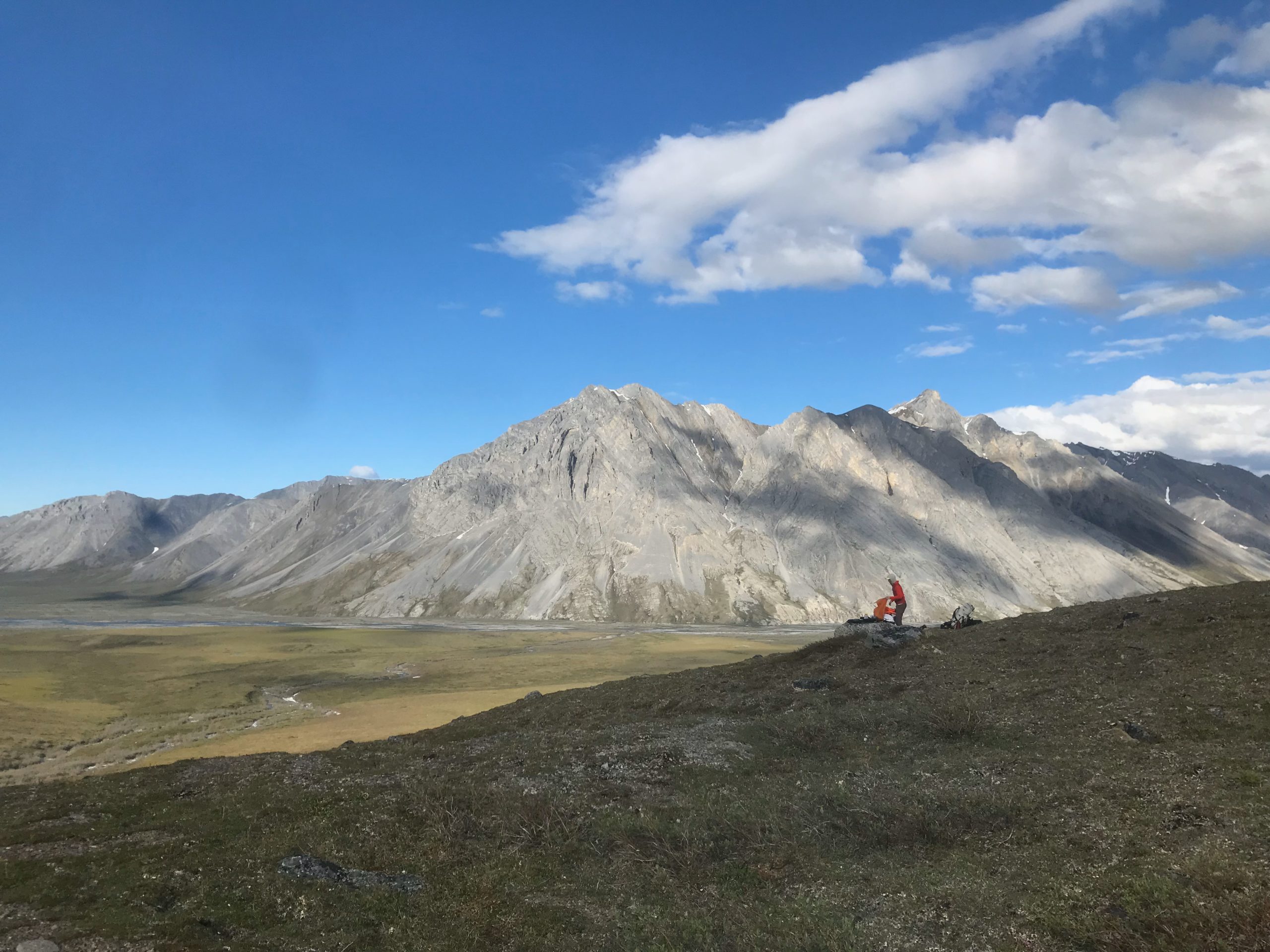 A hiker stops for a break in the Arctic National Wildlife Refuge