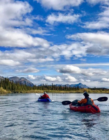 Packrafters paddle down a river in Alaska's Arctic National Wildlife Refuge