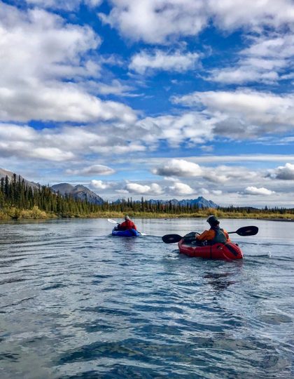 Packrafters paddle down a river in Alaska's Arctic National Wildlife Refuge